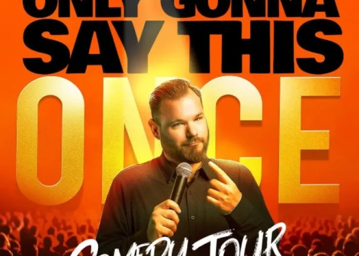 Name of comedy tour, Jeff Leeson with microphone, crowd in seats